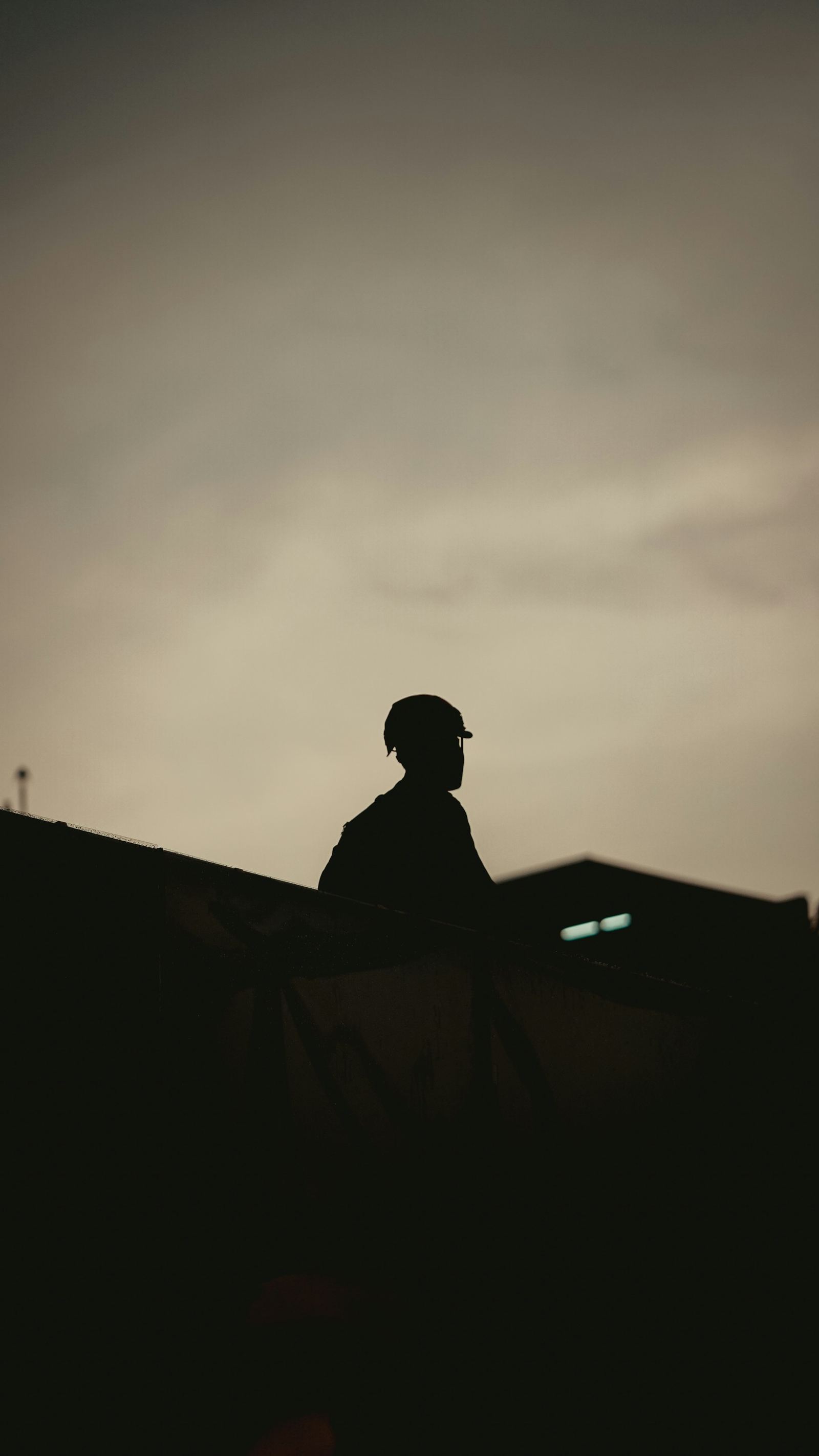 Lone figure in a hard hat against the dusk